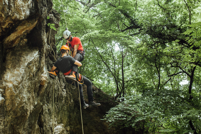 Mountain rescuer helping injured climber